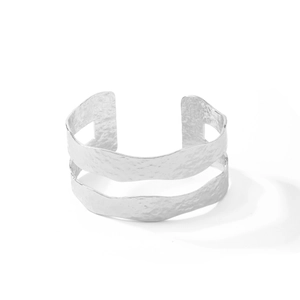 Detail of silver dual-layer open cuff bracelet with hammered texture and hollow design