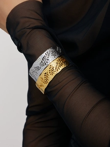 Detail of 18K gold and silver plated open leaf bracelets with hammered texture on black mesh