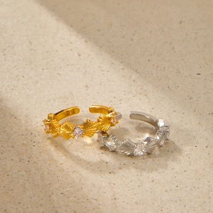 Dettaglio macro di ear cuff retrò in oro e argento con zirconi brillanti incastonati