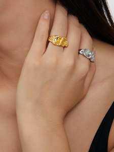 Close-up of gold and silver lava texture rings featuring liquid metal aesthetic