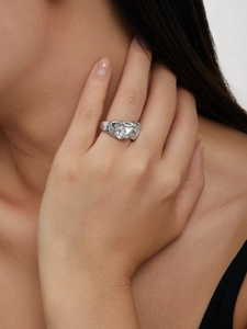 Macro detail of 18K gold irregular lava texture statement ring on model finger