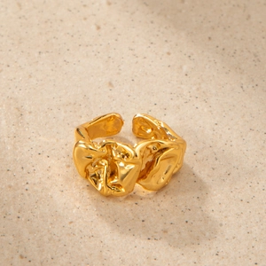 Macro shot of 18K gold plated molten lava ring with irregular textured polished surface