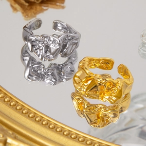 Macro shot of 18K gold and silver lava rings with irregular texture and mirror finish