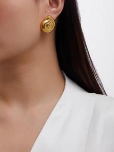 Close-up of a 18K gold-plated spiral snail shell earring on model with polished finish