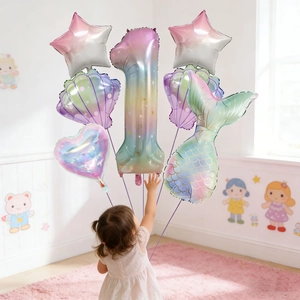 Child touching 7-piece pastel gradient mermaid balloon set with number one for birthday