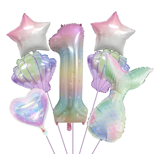 Detail of mermaid themed foil balloon set with rainbow gradient and shell shapes