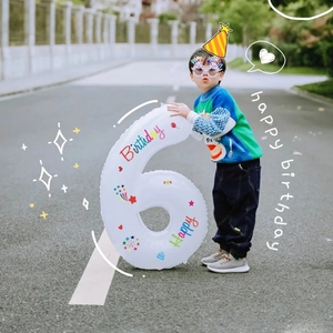 Detail of white 40 inch number 6 foil balloon with colorful Happy Birthday print for kids