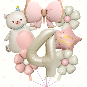Macro detail of cream bear, pink bow, and number 4 balloons for girls birthday party