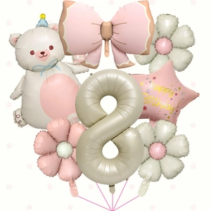 Detail view of cream bear and bow foil balloons set for 8th birthday party decoration