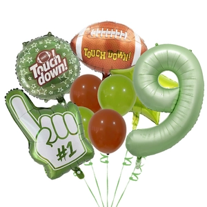 Detail of rugby themed party balloons including football foil, green number 9 and latex balloons