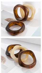 Macro shot of thick tortoiseshell acrylic bangles with elegant wavy texture design