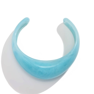 Blue marble resin open wide cuff bracelet with geometric punk design on white backdrop
