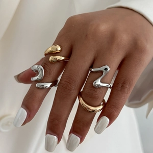 Polished liquid metal style rings in gold and silver finish on a model hand