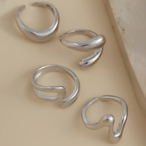 Detail of silver liquid metal rings with irregular geometric and organic shapes