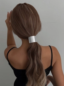 Back view of silver metallic geometric ponytail cuff with high-shine mirror finish