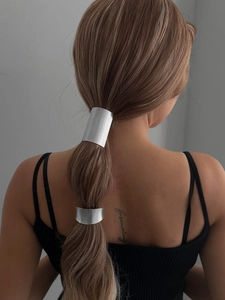 Detail showing two sizes of matte silver alloy ponytail hair cuffs on a model
