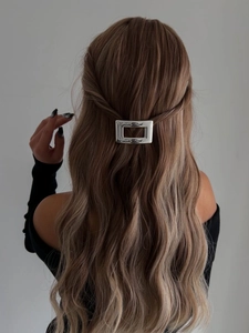 Détail d'une pince à cheveux rectangulaire argentée avec finition martelée sur cheveux