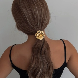Elegant gold flower hair tie with layered metal petals for women's ponytail styles