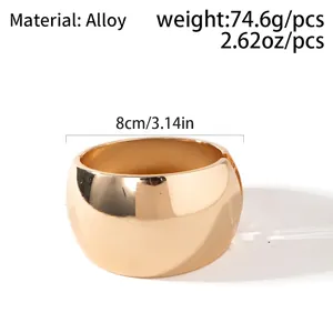 Detailed view of polished gold alloy wide cuff bracelet with 8cm diameter and 74.6g weight