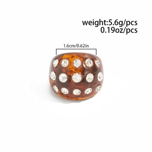 Detail of amber resin ring with rhinestones showing 1.6cm inner diameter and 5.6g weight