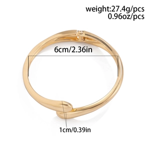 Detail view of a gold-tone teardrop bangle with dimensions and spring hinge mechanism