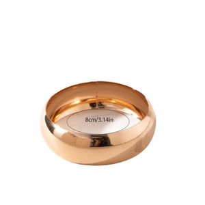 Polished gold wide geometric bangle with 8cm diameter and minimalist mirror finish