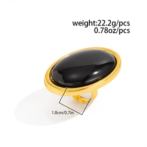 Detailed view of oval black resin stone ring with adjustable golden band and 1.8cm width