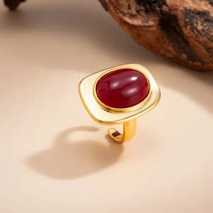 Detail of vintage gold ring with large red oval gemstone and adjustable band