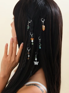 Bohemian hair rings with butterfly and mushroom charms on ethnic braided hairstyle