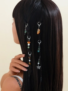 Detail of ethnic style hair braid rings with butterfly charms and natural stones