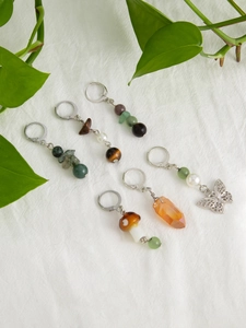 Flat lay of ethnic tassel hair charms with natural stones, pearls and metal butterfly
