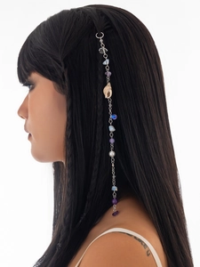 Detail of silver hair chain with natural seashells, pearls and colorful mineral stones