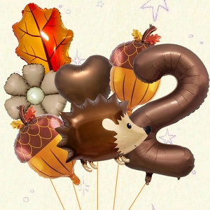 Detail of fall harvest balloon set with hedgehog, maple leaf, and acorn for party decor