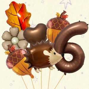 Detail of autumn harvest hedgehog and maple leaf foil balloon set for a 6th birthday party