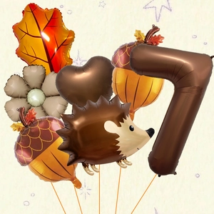 Detail of hedgehog and maple leaf foil balloons set for autumn harvest party decoration