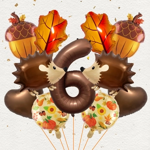 Detail of fall theme balloon kit featuring hedgehog, acorns and maple leaves