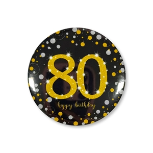 Detail of 58mm black and gold 80th birthday tinplate badge with shiny glitter numbers