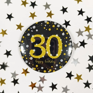 Close-up of 58mm black and gold 30th happy birthday tinplate badge with star sequins
