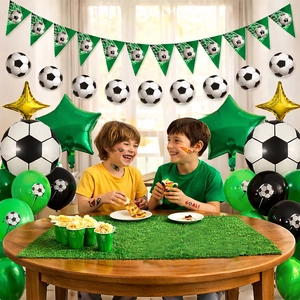 Soccer party decoration set with football foil balloons and green themed accessories
