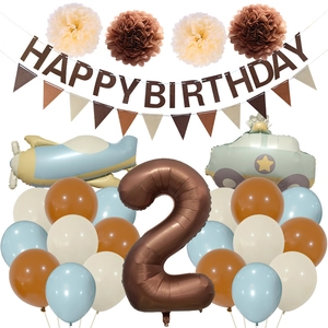 Macro detail of vintage matte birthday party set with aircraft car balloons and felt banner