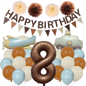 Detail view of birthday party set with felt banner, paper pom poms and airplane balloons