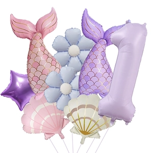 Detail of mermaid shell foil balloon set with purple number one for birthday decor