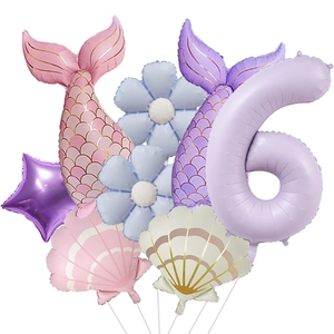 Detail of 6th birthday mermaid balloon set with purple number 6 and seashell foil decor