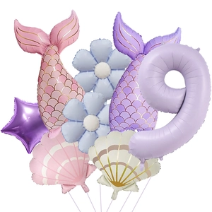 Detail of mermaid party balloon set including purple number 9 and colorful fish tails