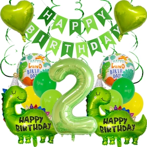 Close-up of green dinosaur birthday party set with balloons and happy birthday banner