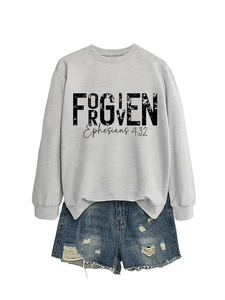 Flat lay of gray Forgiven Ephesians 4:32 sweatshirt paired with blue denim shorts