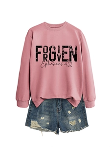 Detail showing the FORGIVEN text and Ephesians 4:32 print on a pink crewneck sweatshirt