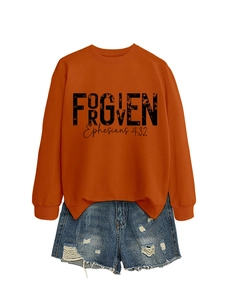 Detailed flat lay of a burnt orange sweatshirt with FORGIVEN print and denim shorts