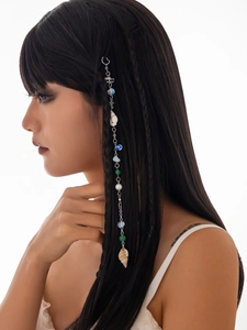 Detail of beach hair chain with colorful beads, pearl, and natural conch shell pendant