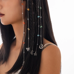 Detail of bohemian long hair chain featuring colorful natural stones and metal charms